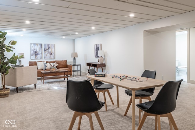 dining space with recessed lighting and light carpet