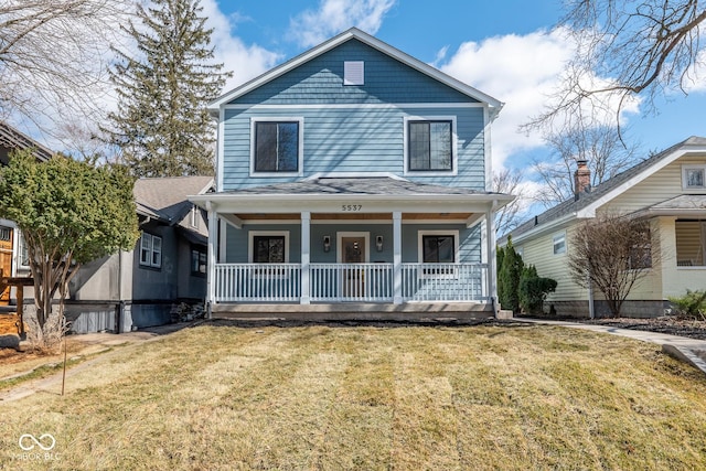 view of front of property with covered porch and a front yard