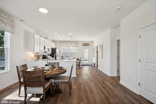 dining area with dark wood-style floors, recessed lighting, visible vents, and baseboards