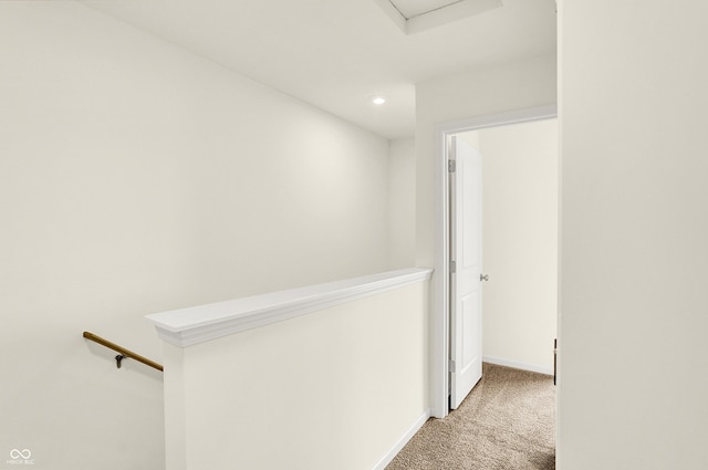 hallway with recessed lighting, carpet, baseboards, and an upstairs landing