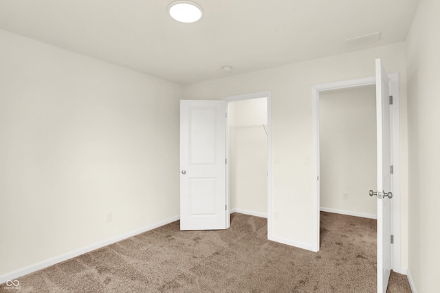 unfurnished bedroom featuring carpet floors, a closet, and baseboards