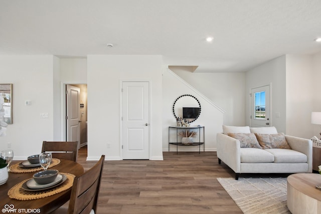 living room with recessed lighting, baseboards, and wood finished floors