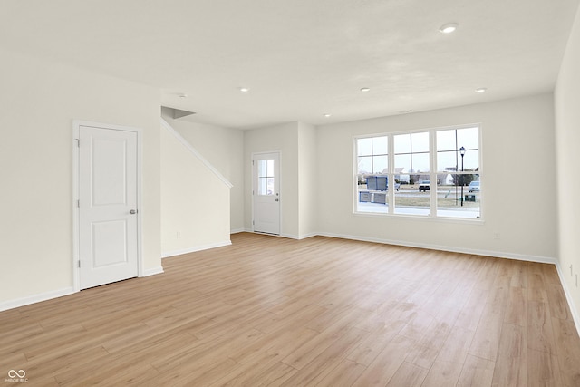 unfurnished room with light wood-type flooring, baseboards, and recessed lighting