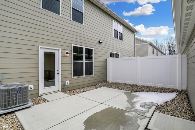 rear view of house featuring a patio area, fence, and cooling unit