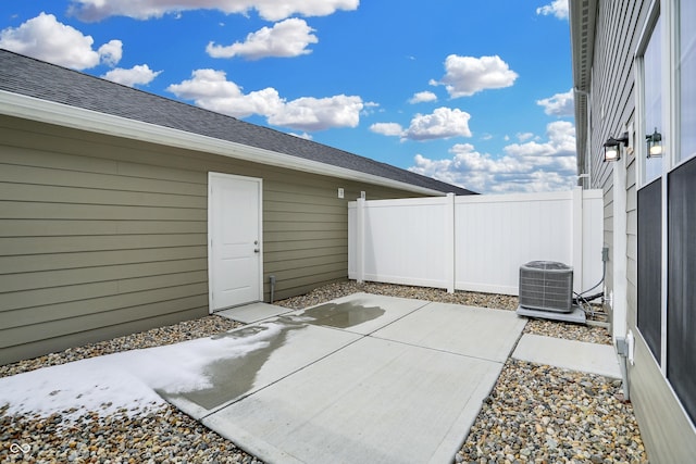 view of patio with fence and central AC unit