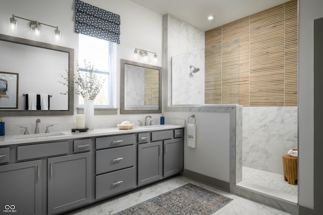 bathroom featuring a walk in shower, marble finish floor, double vanity, and a sink