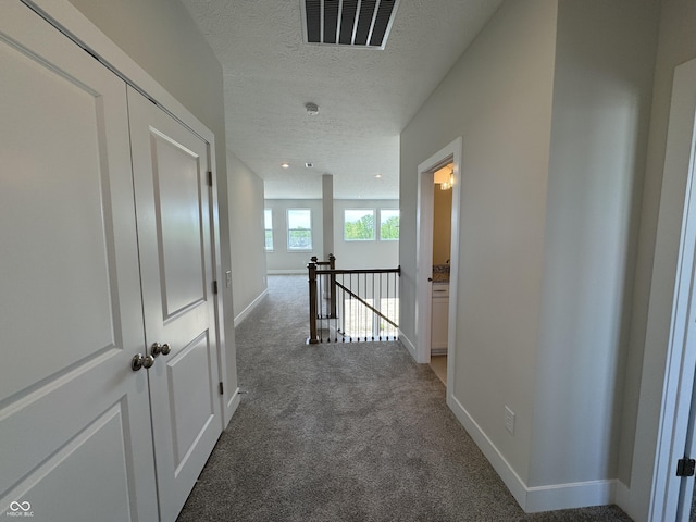 15871 Vitalize Run, Fishers, IN 46040 - corridor featuring an upstairs landing, carpet flooring, a textured ceiling, and baseboards