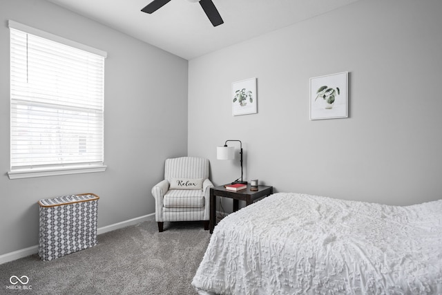 carpeted bedroom with a ceiling fan and baseboards