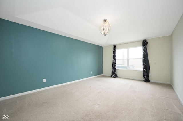 empty room featuring carpet flooring and baseboards