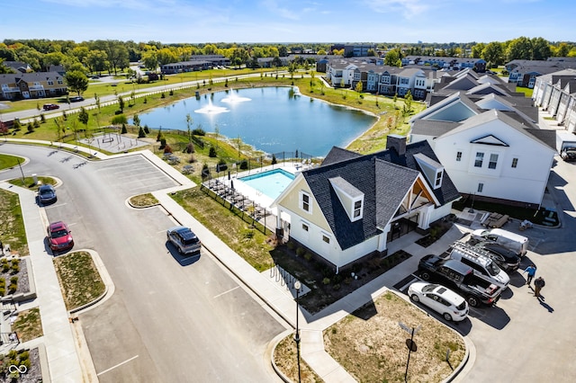 drone / aerial view featuring a water view and a residential view