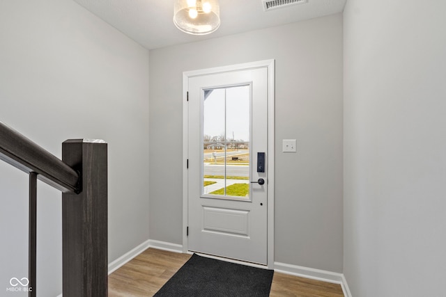 entryway with light wood-type flooring, visible vents, and baseboards