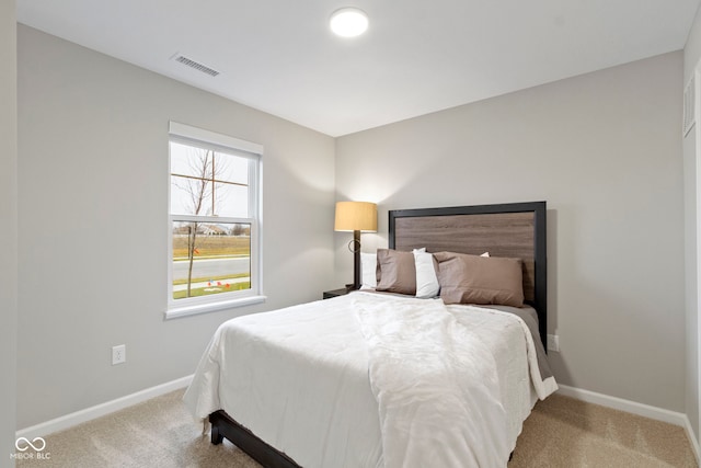 bedroom with baseboards, visible vents, and carpet flooring