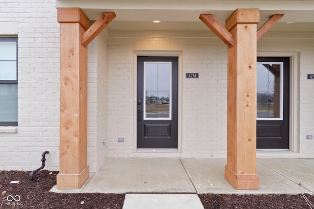 property entrance with brick siding