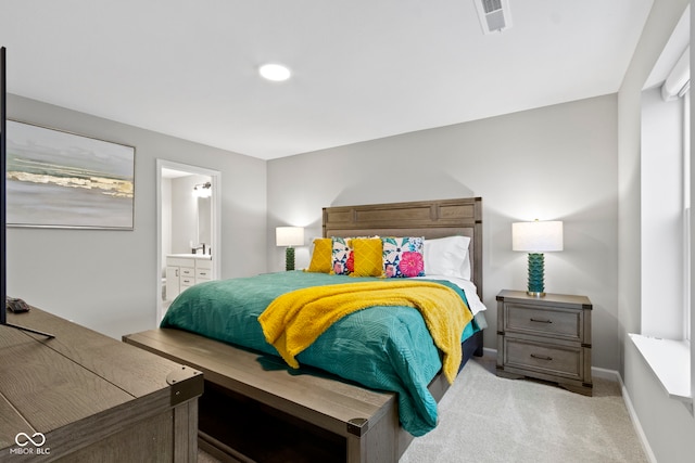 bedroom with carpet floors, visible vents, ensuite bath, and baseboards