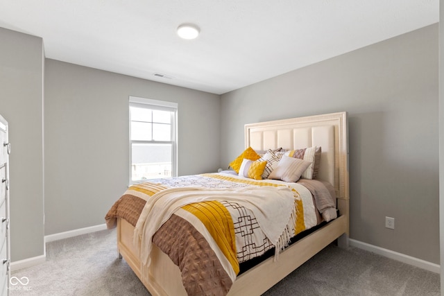 carpeted bedroom featuring visible vents and baseboards