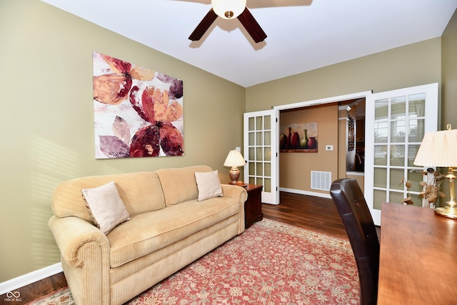 living area featuring wood finished floors, baseboards, visible vents, ceiling fan, and french doors