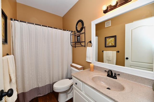 bathroom with visible vents, toilet, and vanity