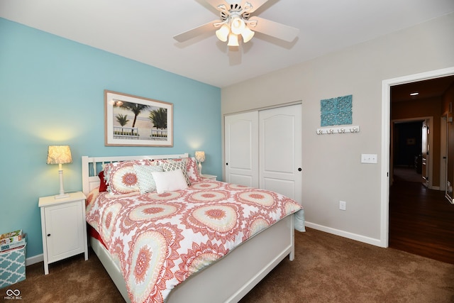 bedroom featuring dark colored carpet, a closet, baseboards, and a ceiling fan