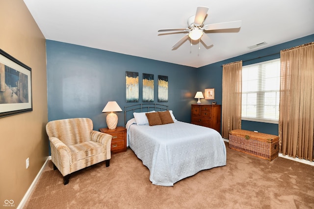 carpeted bedroom featuring visible vents, baseboards, and a ceiling fan