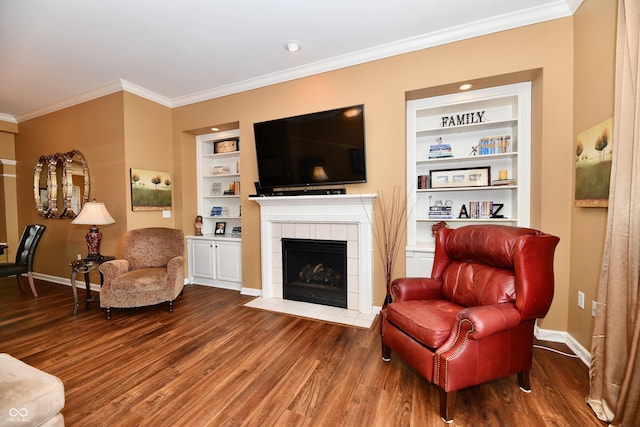 living room with built in shelves, wood finished floors, and baseboards