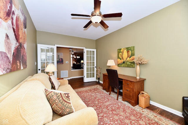 home office with ceiling fan, visible vents, baseboards, and wood finished floors