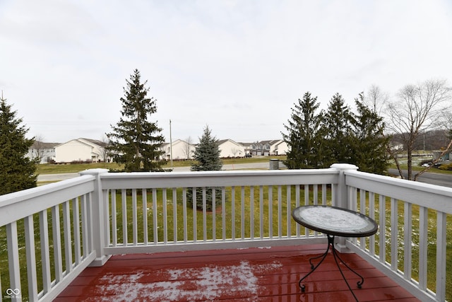 wooden terrace featuring a residential view and a lawn