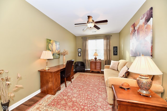 living room with visible vents, baseboards, ceiling fan, and wood finished floors