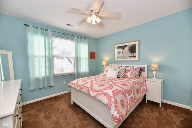 bedroom featuring dark colored carpet, visible vents, baseboards, and ceiling fan