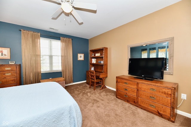 carpeted bedroom featuring visible vents, baseboards, and a ceiling fan