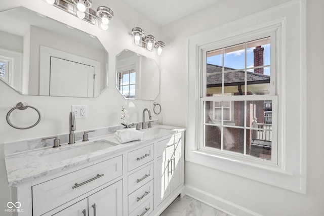 3645 N Delaware St, Indianapolis, IN 46205 - bathroom with double vanity, baseboards, marble finish floor, and a sink