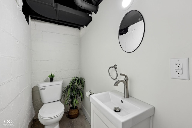 3645 N Delaware St, Indianapolis, IN 46205 - half bath with concrete block wall, vanity, toilet, and concrete flooring