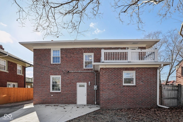 3645 N Delaware St, Indianapolis, IN 46205 - rear view of property with brick siding, a patio, a balcony, and fence