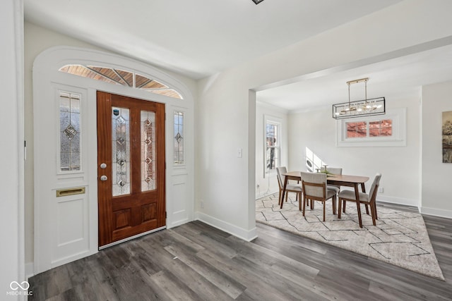 3645 N Delaware St, Indianapolis, IN 46205 - entrance foyer with dark wood-style floors, a chandelier, and baseboards