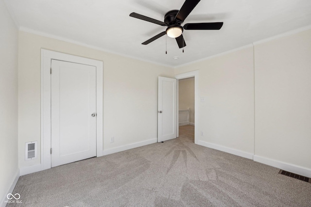 3645 N Delaware St, Indianapolis, IN 46205 - unfurnished bedroom featuring ornamental molding, visible vents, and light carpet