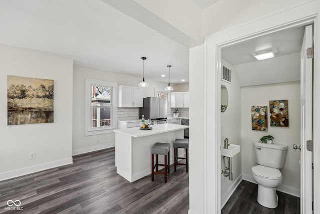 3645 N Delaware St, Indianapolis, IN 46205 - interior space featuring tasteful backsplash, toilet, baseboards, and wood finished floors