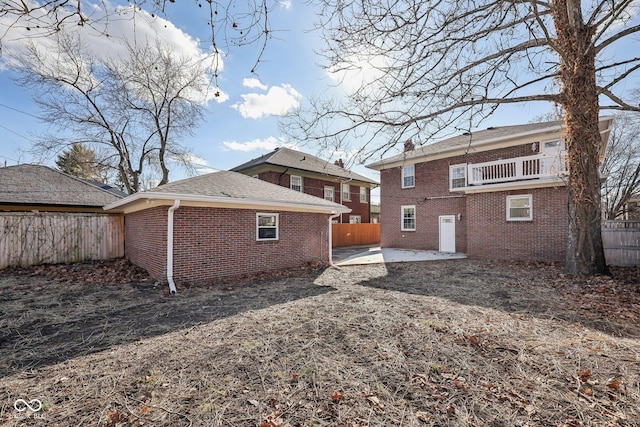 3645 N Delaware St, Indianapolis, IN 46205 - back of house with brick siding, a patio, a chimney, and a fenced backyard