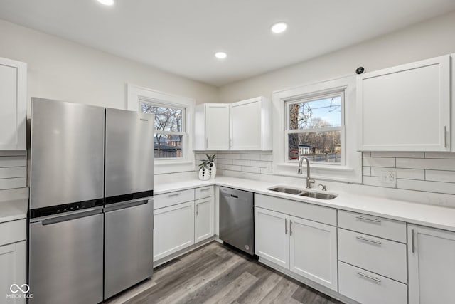 3645 N Delaware St, Indianapolis, IN 46205 - kitchen featuring a sink, tasteful backsplash, appliances with stainless steel finishes, and light countertops