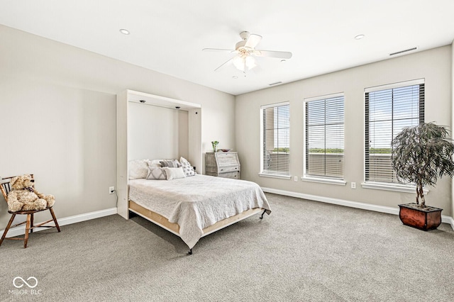 carpeted bedroom with baseboards, visible vents, and ceiling fan