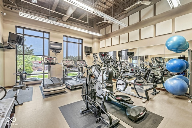 exercise room with a towering ceiling