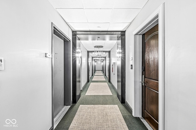 corridor featuring dark colored carpet