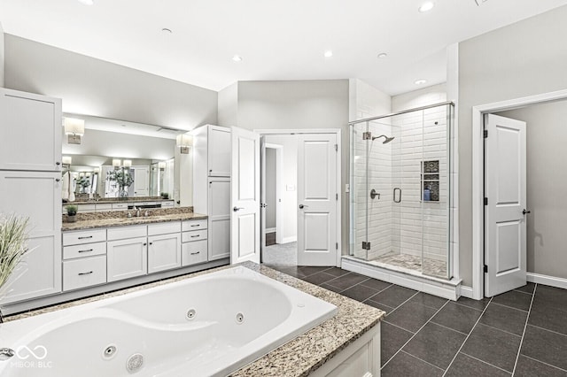 bathroom featuring baseboards, a tub with jets, tile patterned flooring, vanity, and a shower stall