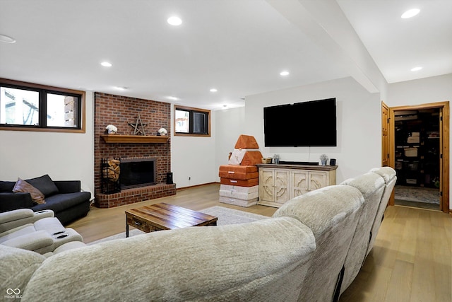 living room with recessed lighting, light wood-style flooring, a fireplace, and baseboards