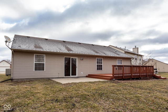 back of property with roof with shingles, a patio, a lawn, central AC, and a deck