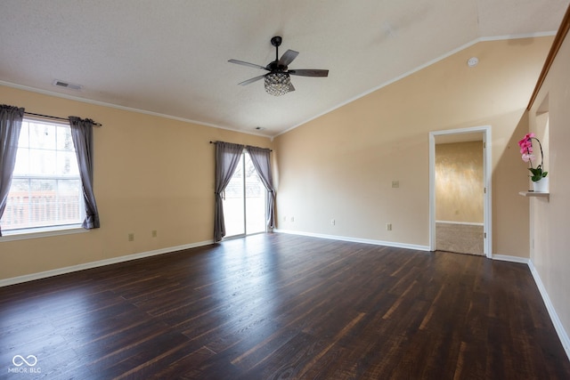 unfurnished room with lofted ceiling, dark wood-style flooring, visible vents, and plenty of natural light