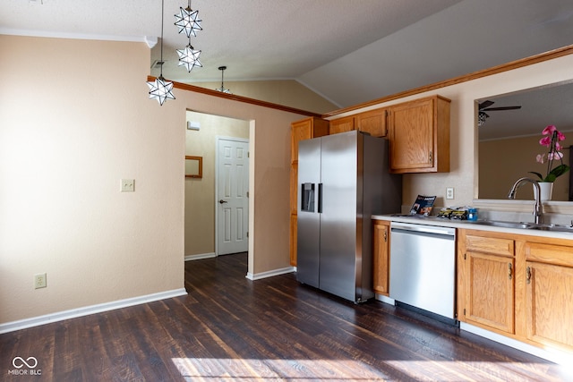 kitchen featuring dark wood-type flooring, vaulted ceiling, stainless steel appliances, and a sink