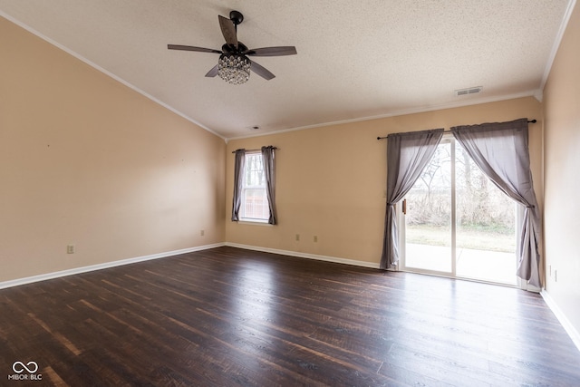 unfurnished room featuring lofted ceiling, a textured ceiling, wood finished floors, and visible vents