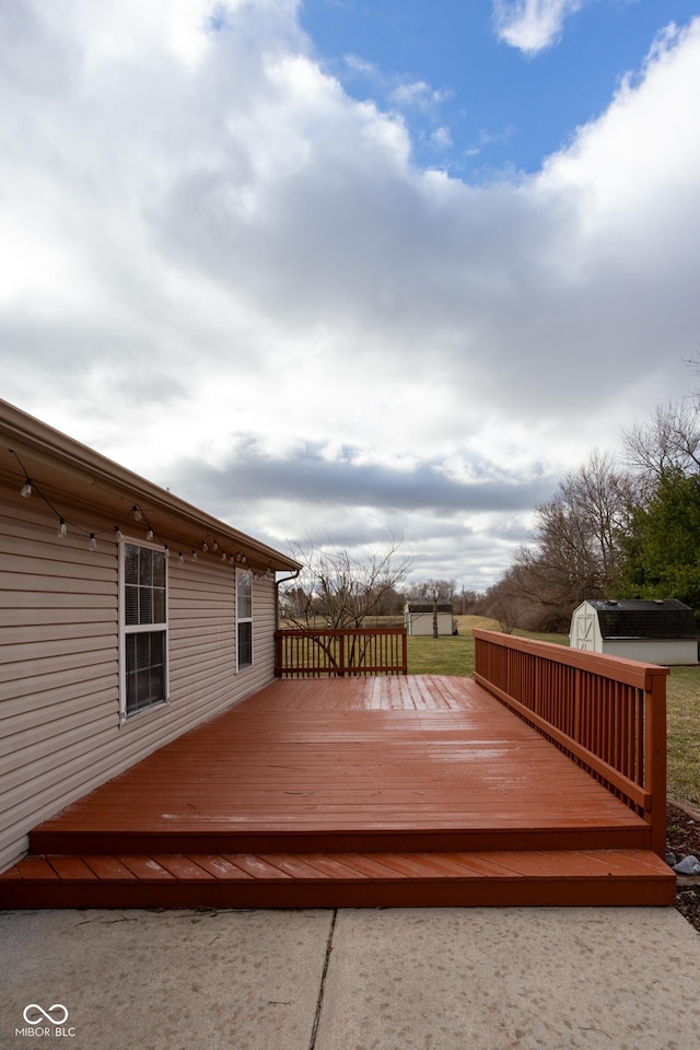 deck featuring an outbuilding and a storage unit