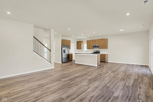 7168 Jackson Dr, Cumberland, IN 46229 - kitchen featuring recessed lighting, light wood-style floors, appliances with stainless steel finishes, and open floor plan