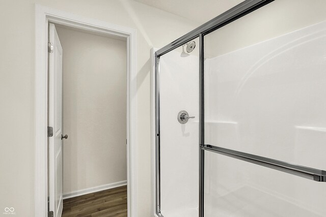 7168 Jackson Dr, Cumberland, IN 46229 - bathroom with baseboards, wood finished floors, and a shower stall