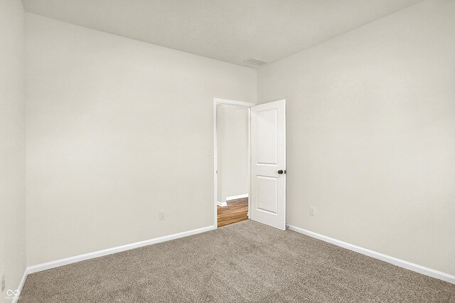 7168 Jackson Dr, Cumberland, IN 46229 - carpeted empty room with visible vents and baseboards